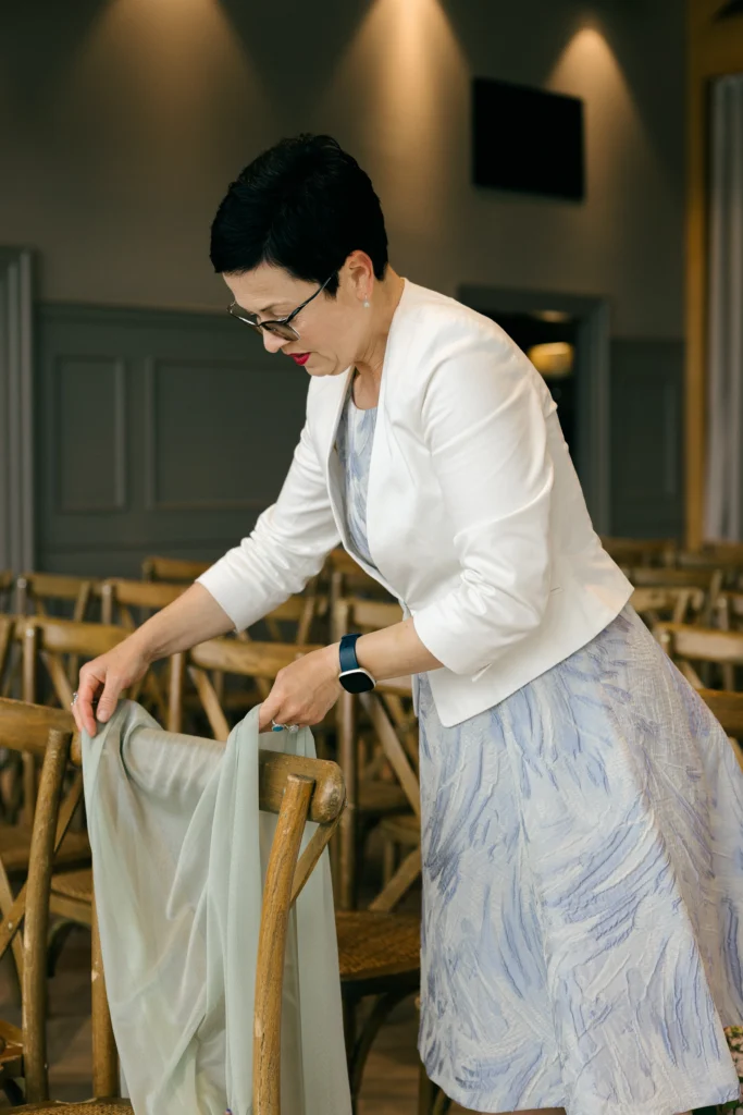 Oana from Inspired By You dressing ceremony chairs at Alex and Patrick's wedding